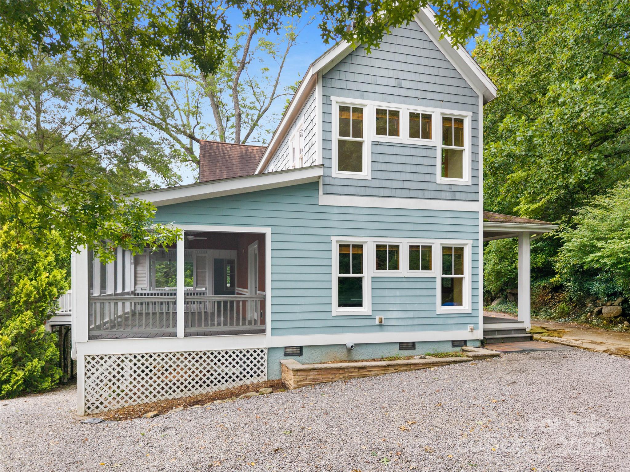 32 Delano Road Asheville, NC 28805 - Photo 2 of 46 a front view of a house with a floor to ceiling window and wooden fence