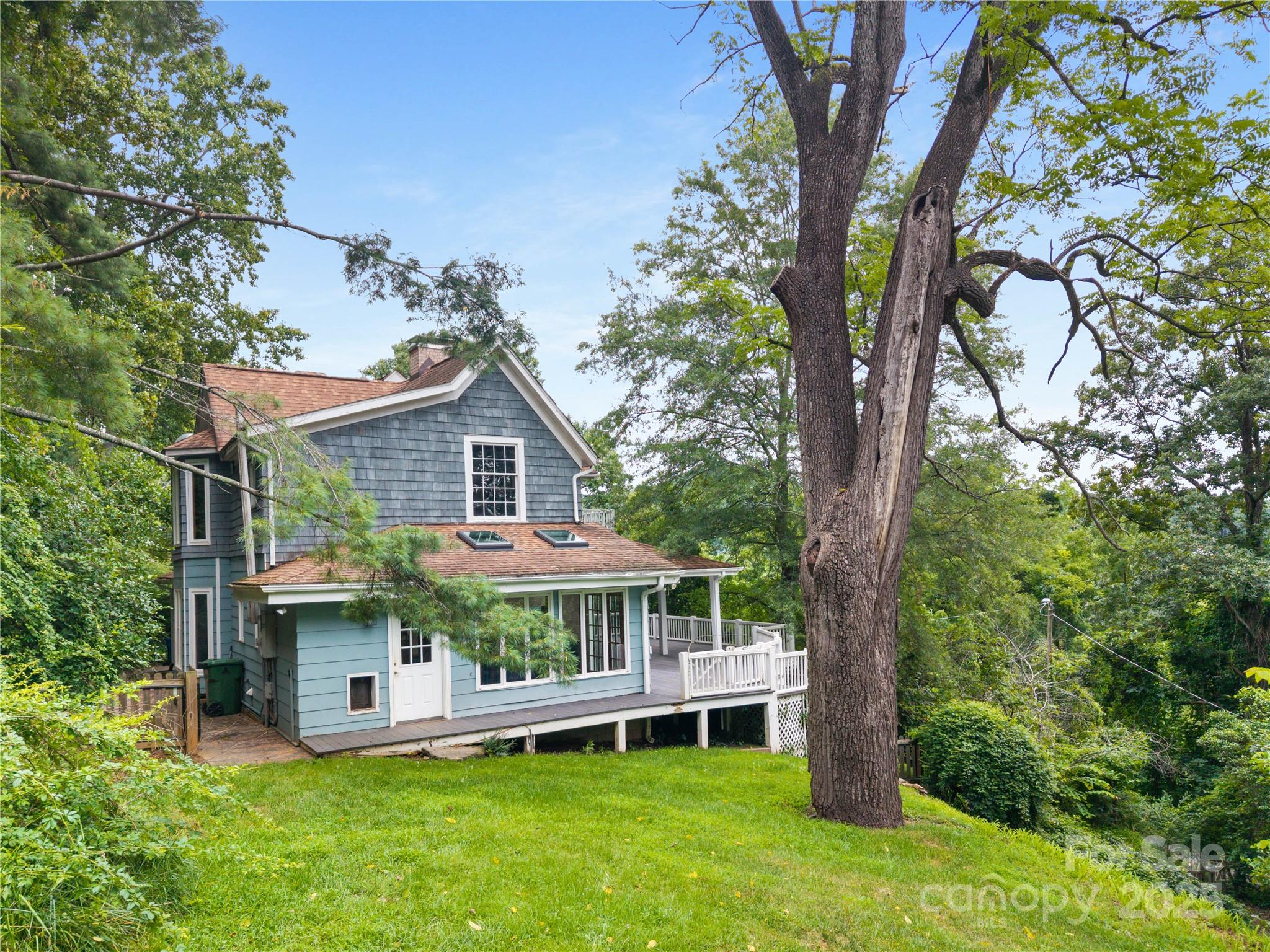 32 Delano Road Asheville, NC 28805 - Photo 45 of 46 a small house with a tree in the grass