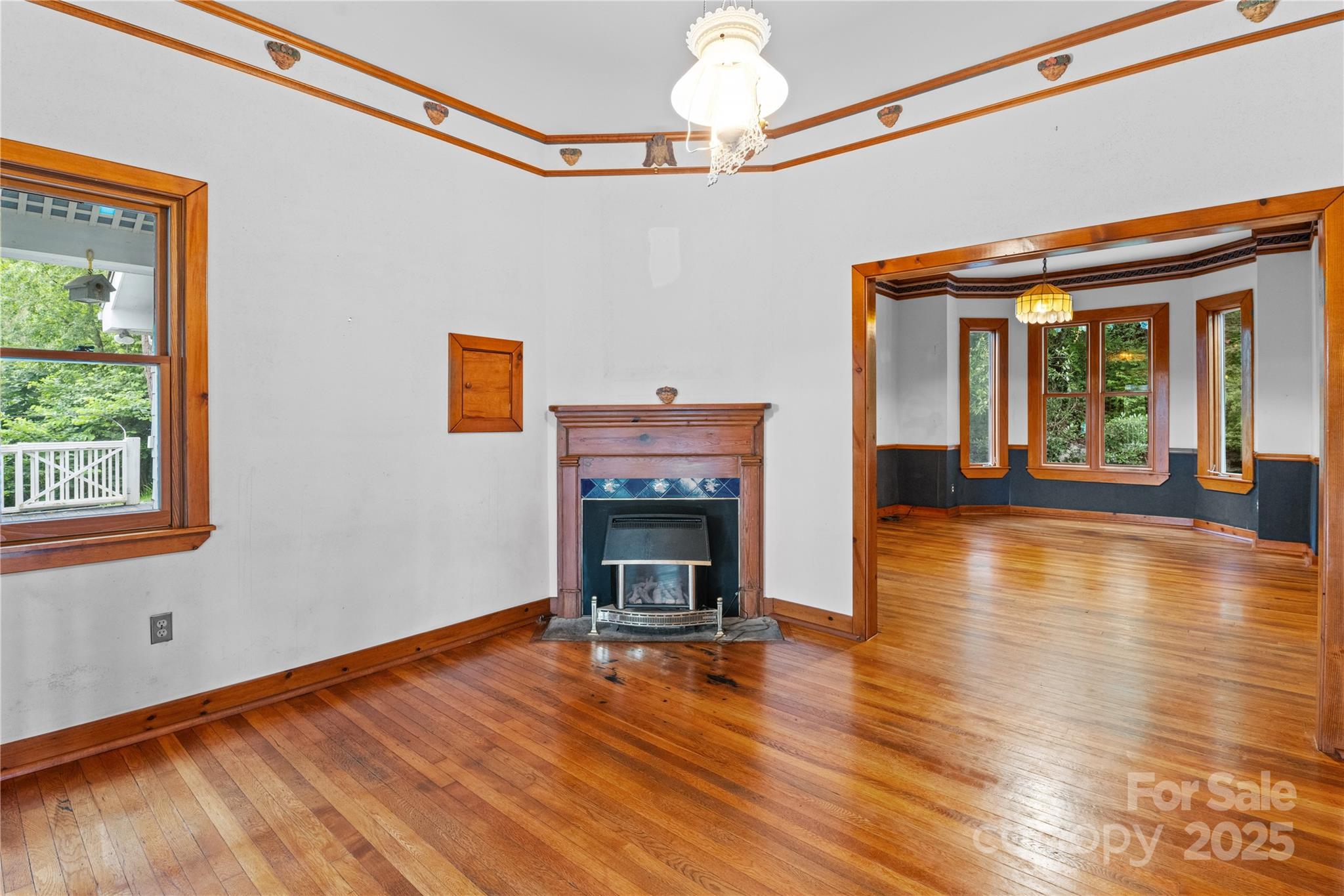 32 Delano Road Asheville, NC 28805 - Photo 8 of 46 a view of an empty room with wooden floor fireplace and a window