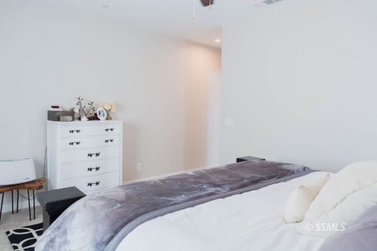 411 Abigail Street Ridgecrest, CA 93555 - Photo 19 of 39 a bedroom with a bed and cabinets