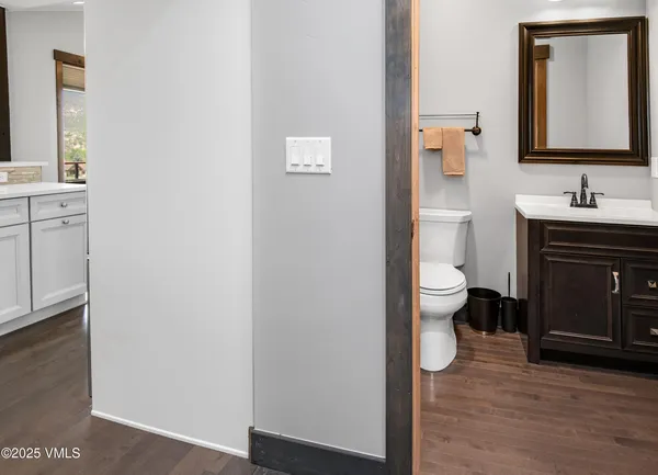 a bathroom with a toilet sink and mirror