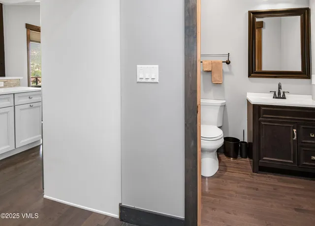 a bathroom with a toilet sink and mirror