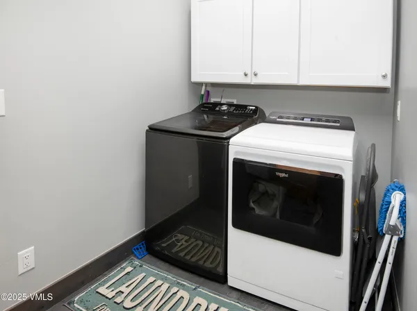 a kitchen with granite countertop a sink cabinets and wooden floor