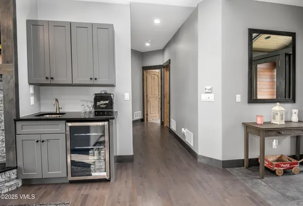a bathroom with a granite countertop toilet and a sink