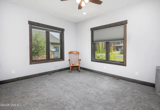 a view of empty room with wooden floor and window