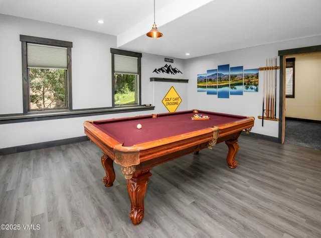 a view of a livingroom with wooden floor and furniture