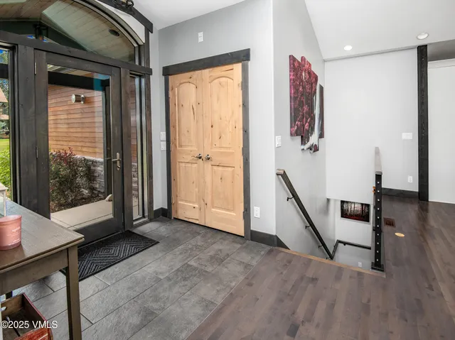 a room with pool table and windows