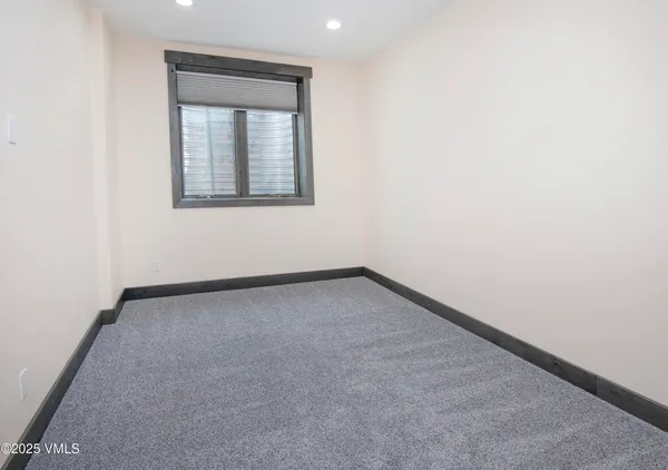 a view of a patio with a table chairs and a swimming pool