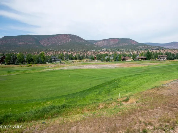 an aerial view of a house with yard and pool