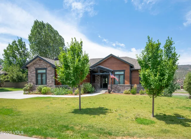 a view of a house with pool and chairs