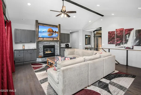 a living room with furniture a flat screen tv and a fireplace