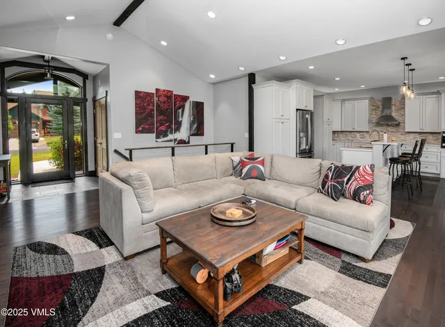 a living room with furniture and kitchen view
