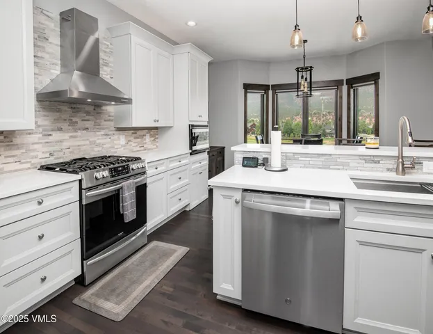 a view of a dining room with furniture wooden floor and a flat screen tv
