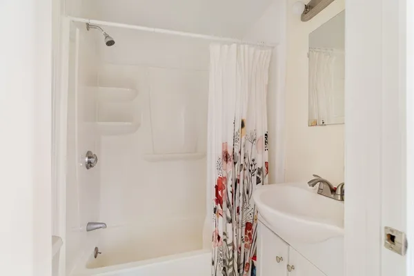 a bathroom with a bathtub and shower