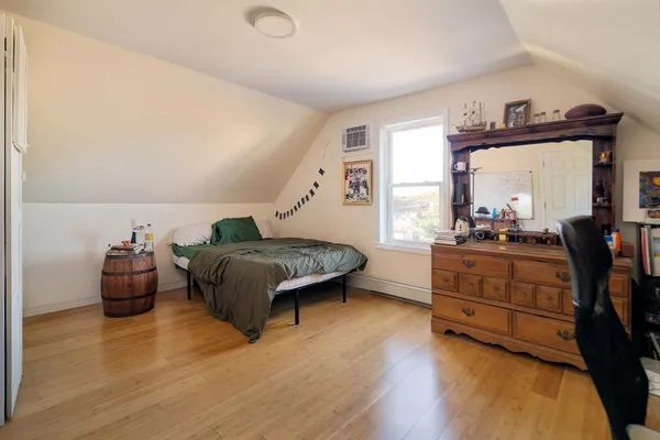 a living room with furniture and a dresser