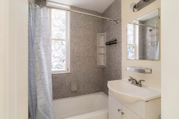 a bathroom with a sink a mirror and a bathtub