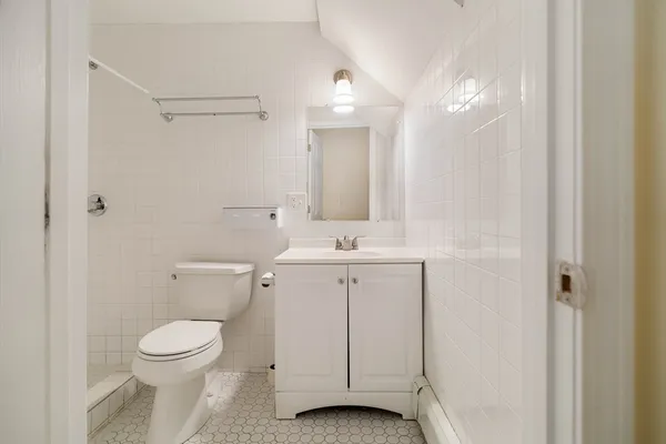 a bathroom with a toilet a sink and a mirror