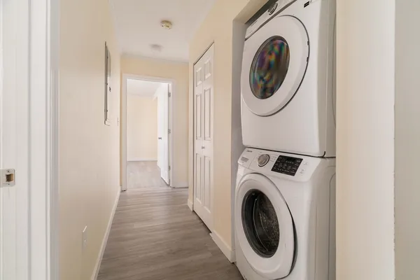 a view of a hallway with washer and dryer