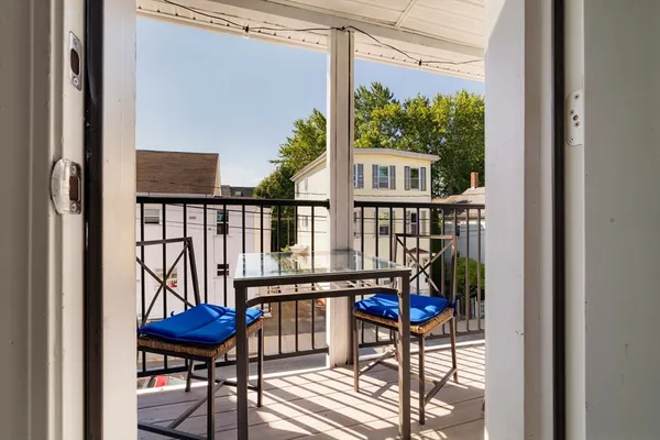 a view of a chairs and table in the balcony