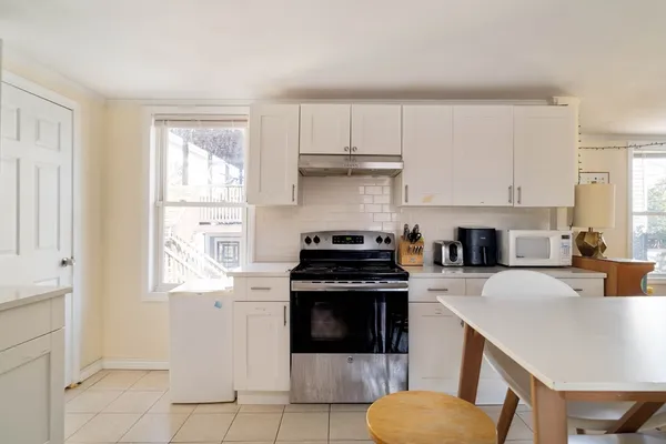 a kitchen with a stove a sink and a refrigerator
