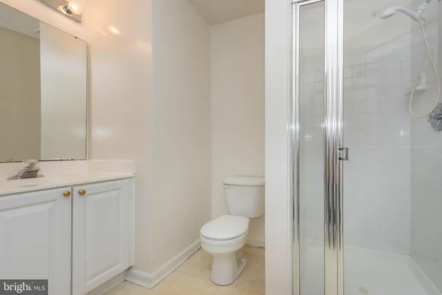 a bathroom with a toilet a sink and a mirror