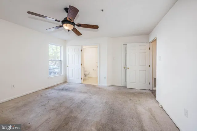 a view of empty room with ceiling fan
