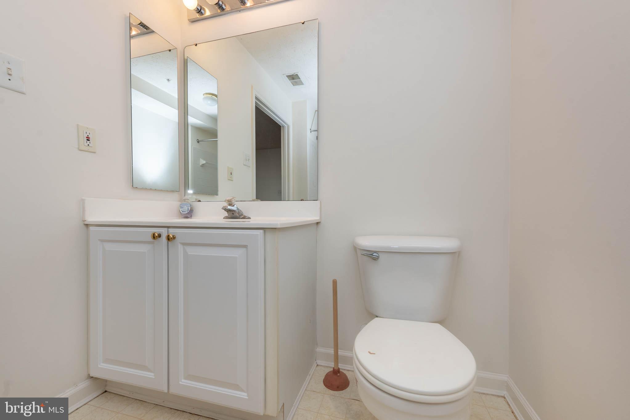 9715 Reese Farm Road, Unit 9715 Owings Mills, MD 21117 - Photo 19 of 25 a bathroom with a toilet a sink and mirror