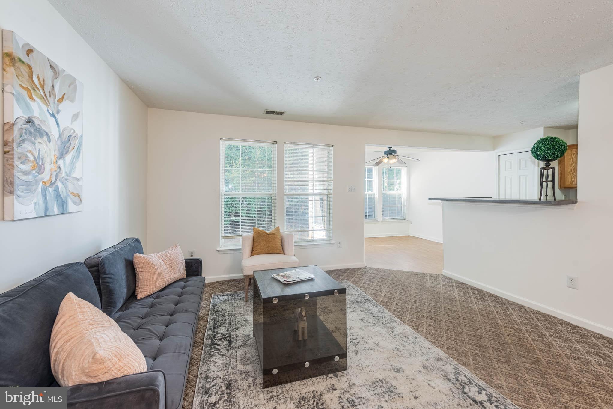 9715 Reese Farm Road, Unit 9715 Owings Mills, MD 21117 - Photo 3 of 25 a living room with furniture and wooden floor