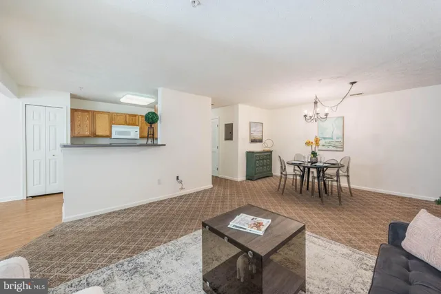 a living room with furniture a rug and a table