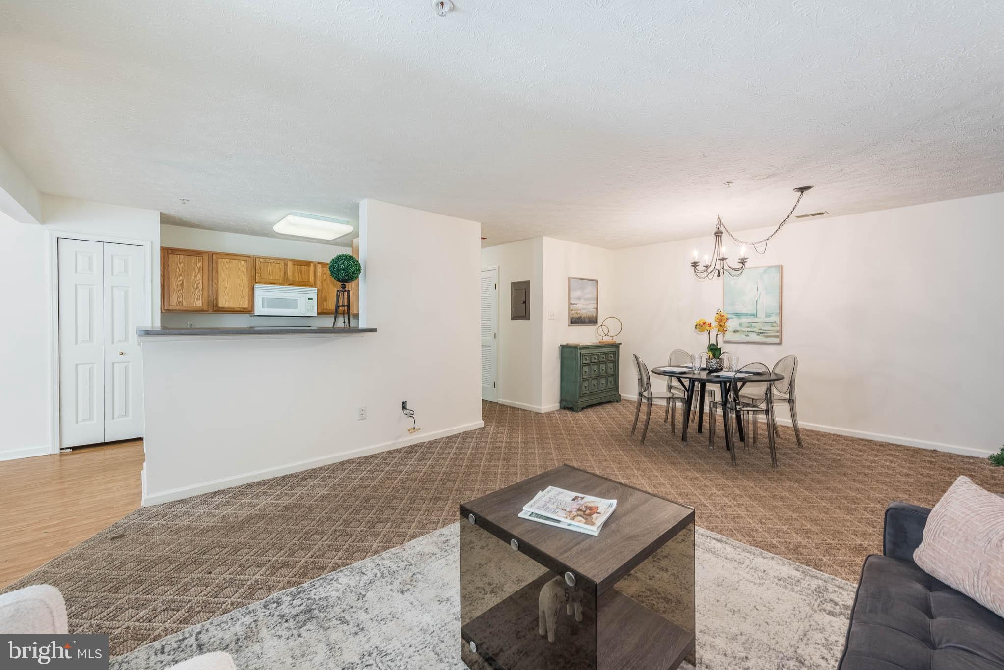 9715 Reese Farm Road, Unit 9715 Owings Mills, MD 21117 - Photo 4 of 25 a living room with furniture a rug and a table