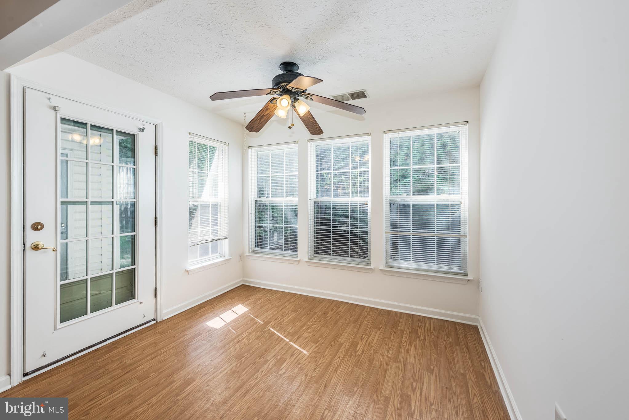 9715 Reese Farm Road, Unit 9715 Owings Mills, MD 21117 - Photo 8 of 25 an empty room with wooden floor and windows