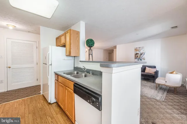 a kitchen with a sink appliances and cabinets