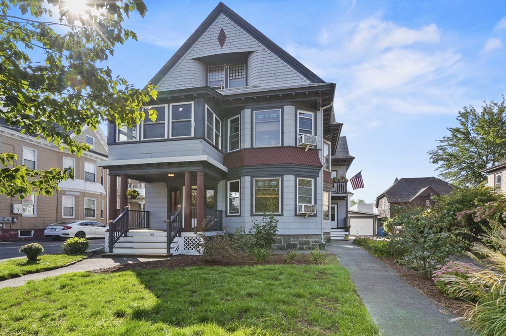a front view of a house with a yard table and chairs