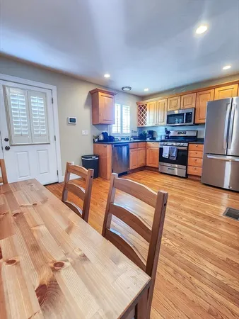 a living room with furniture and kitchen view
