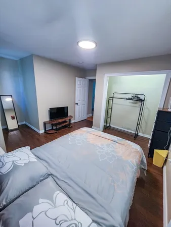 a bedroom with a bed and a television