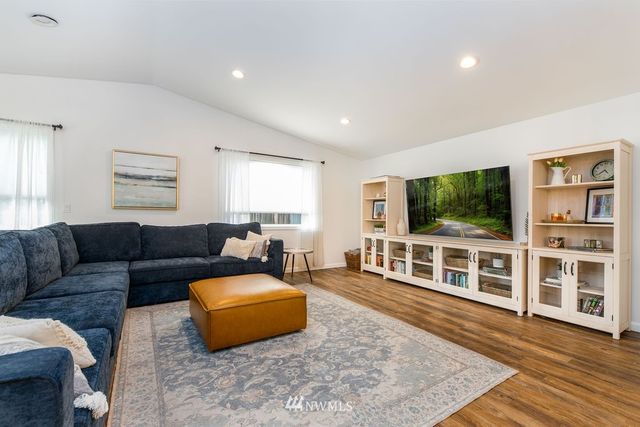 a living room with furniture windows and a flat screen tv