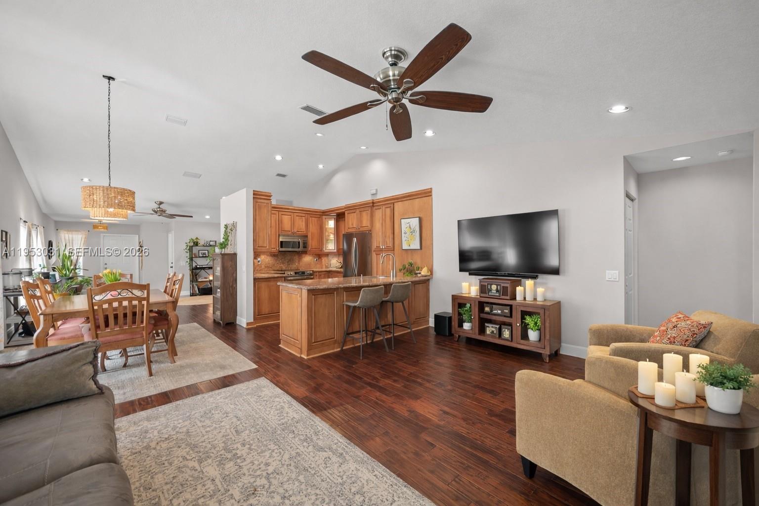 4036 Pine Ridge Lane Weston, FL 33331 - Photo 11 of 19 a living room with furniture kitchen view and a flat screen tv