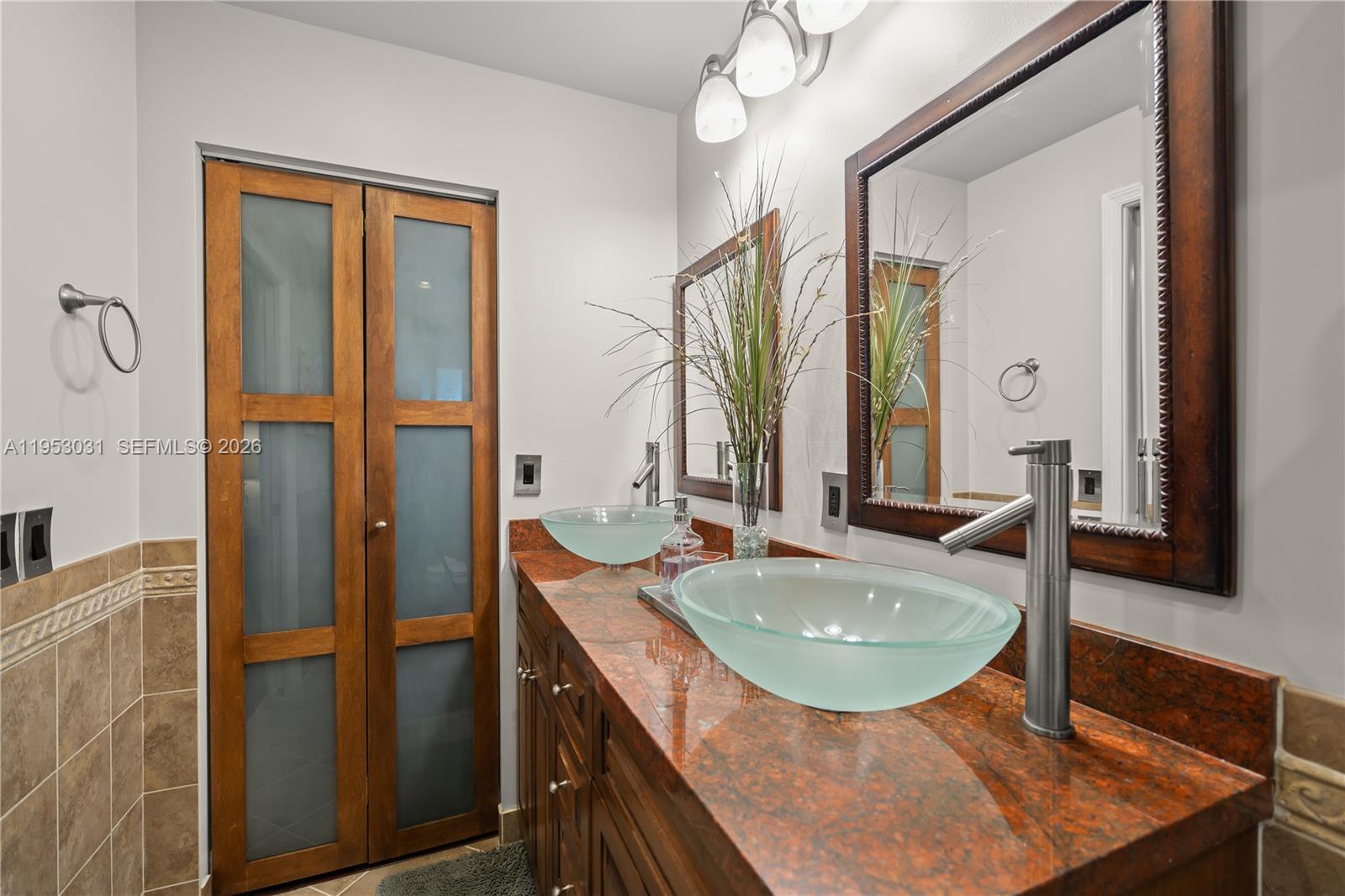 4036 Pine Ridge Lane Weston, FL 33331 - Photo 13 of 19 a bathroom with a sink a mirror and a shower