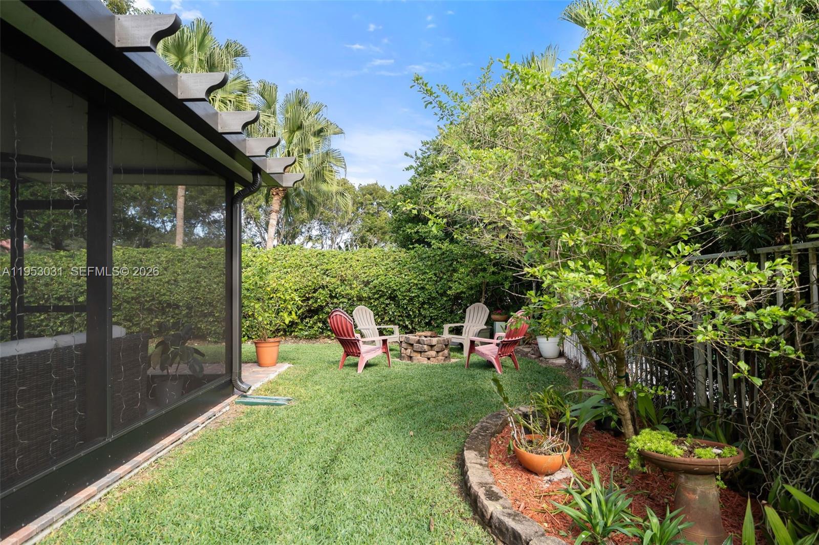 4036 Pine Ridge Lane Weston, FL 33331 - Photo 16 of 19 a view of a chair and table in backyard of the house