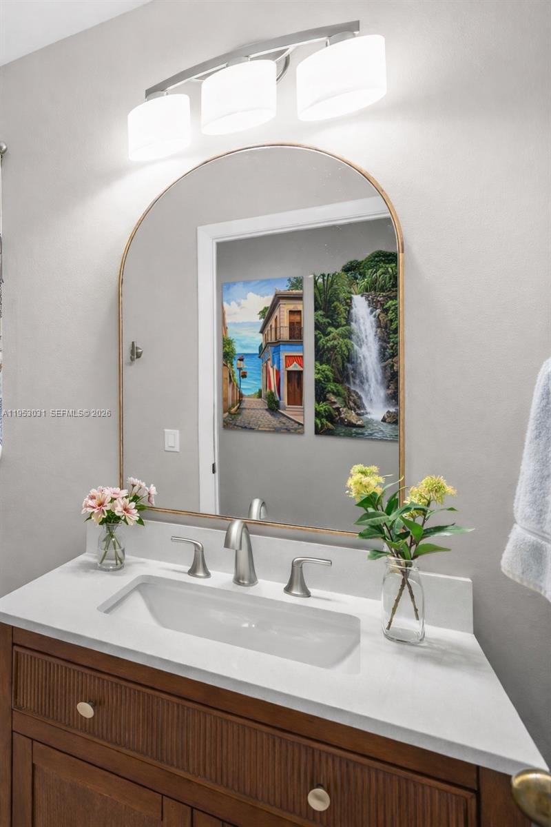 4036 Pine Ridge Lane Weston, FL 33331 - Photo 6 of 19 a bathroom with a sink and a mirror