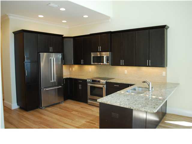 153 Matt's Way Santa Rosa Beach, FL 32459 - Photo 3 of 29 a kitchen with stainless steel appliances kitchen island granite countertop a refrigerator and a stove top oven
