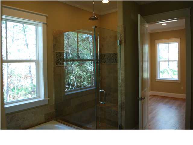 153 Matt's Way Santa Rosa Beach, FL 32459 - Photo 5 of 29 a bathroom with a black tub sink and shower