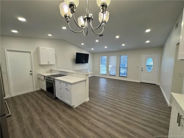 a kitchen with a wooden floor and window