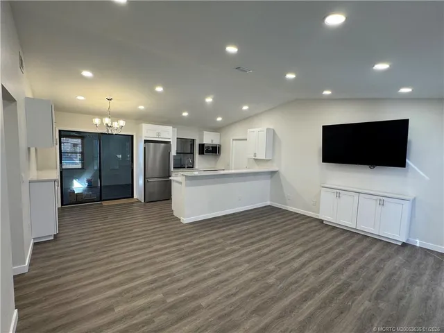 a view of a kitchen with a sink cabinets and wooden floor