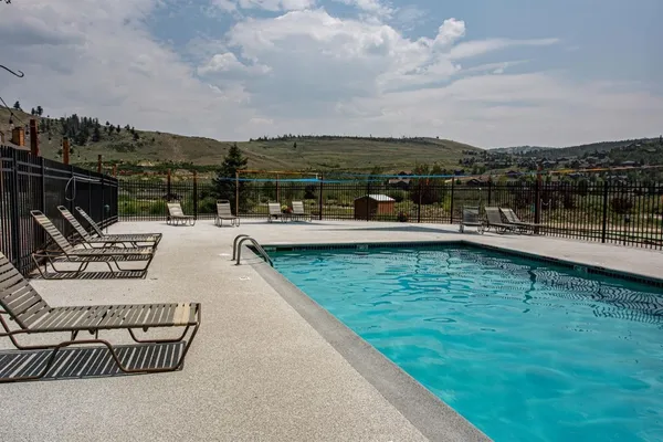 a view of swimming pool with outdoor seating and plants
