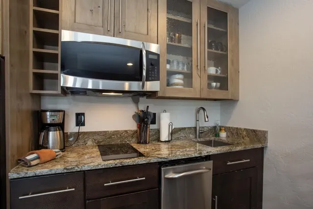 a kitchen with stainless steel appliances granite countertop a sink and cabinets