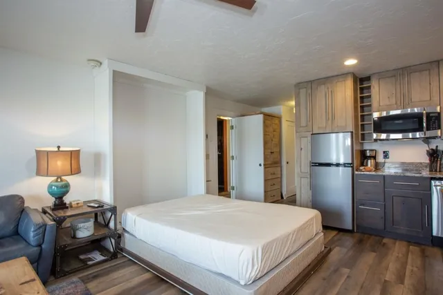 a bedroom with a bed and wooden floor