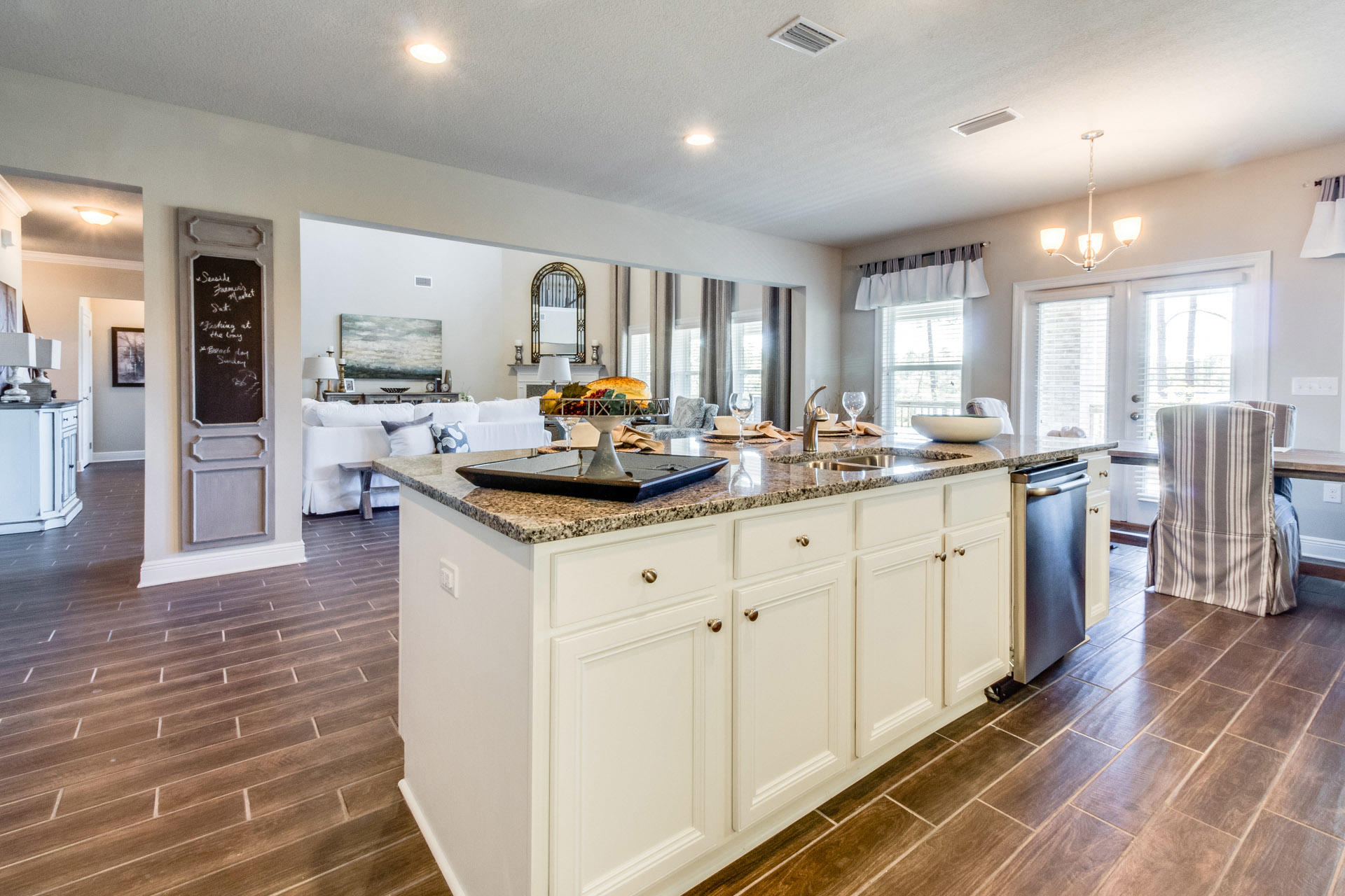 579 Golf Club Drive Santa Rosa Beach, FL 32459 - Photo 15 of 33 a kitchen with stainless steel appliances a sink a stove a refrigerator cabinets and living room view