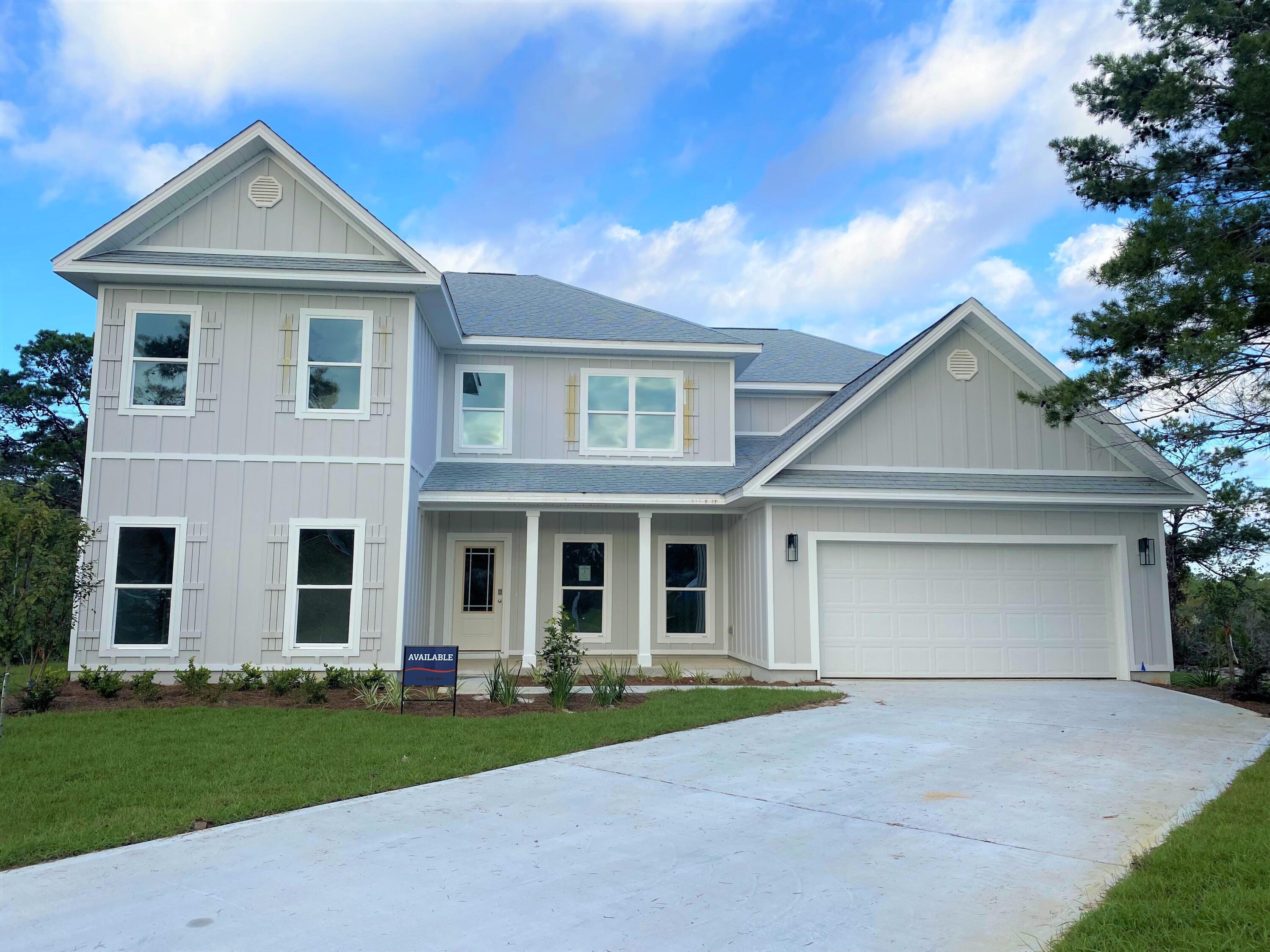579 Golf Club Drive Santa Rosa Beach, FL 32459 - Photo 2 of 33 front view of a house with a yard