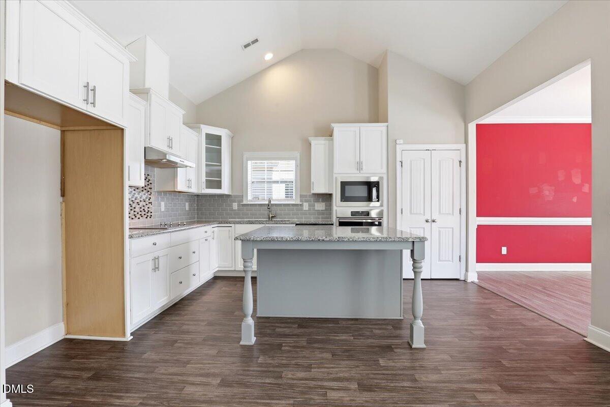 157 Ramsgate Drive Clayton, NC 27520 - Photo 8 of 42 a kitchen with stainless steel appliances a sink cabinets and wooden floor